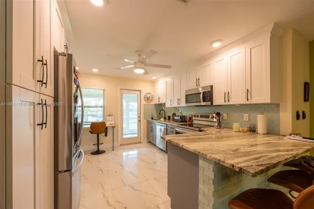 a kitchen with stainless steel appliances a refrigerator and wooden cabinets