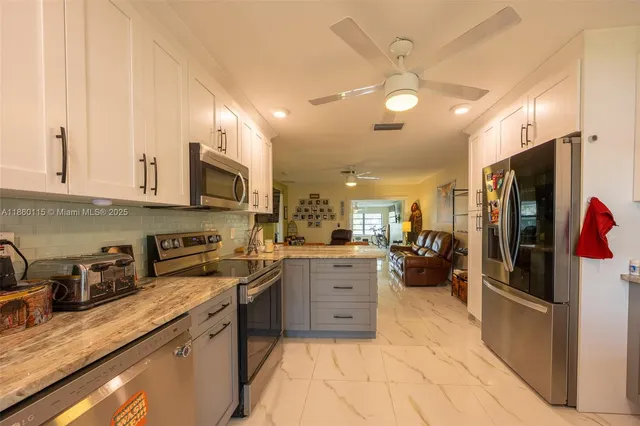 a view of a big yard with table and chairs and a large tree