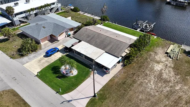 an aerial view of a house with outdoor space lake view and boat