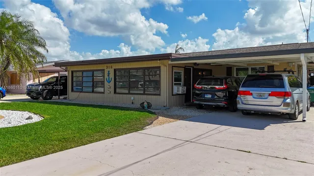 an aerial view of a house with a lake view
