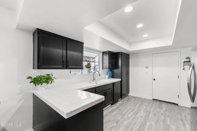 a kitchen with stainless steel appliances granite countertop a refrigerator stove and sink