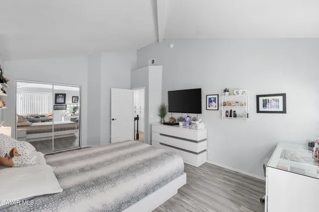 a bedroom with a bed and a desk