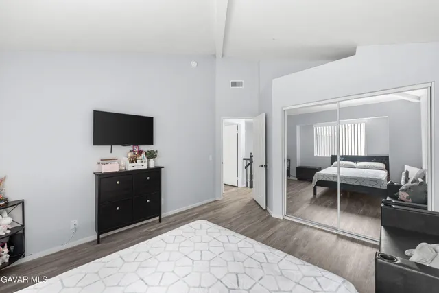 a bedroom with a bed and a couch