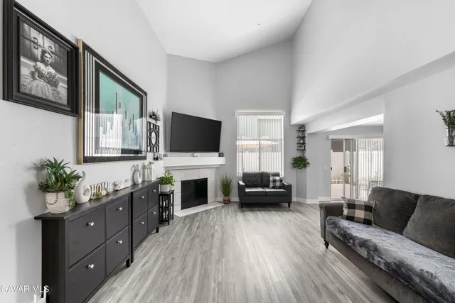 a living room with furniture flat screen tv and wooden floor