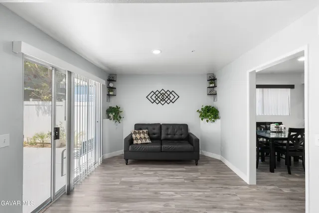 a living room with furniture and a potted plant
