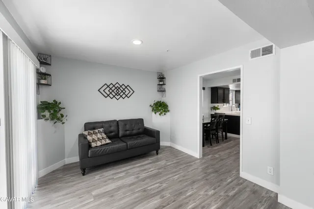 a living room with furniture and a potted plant