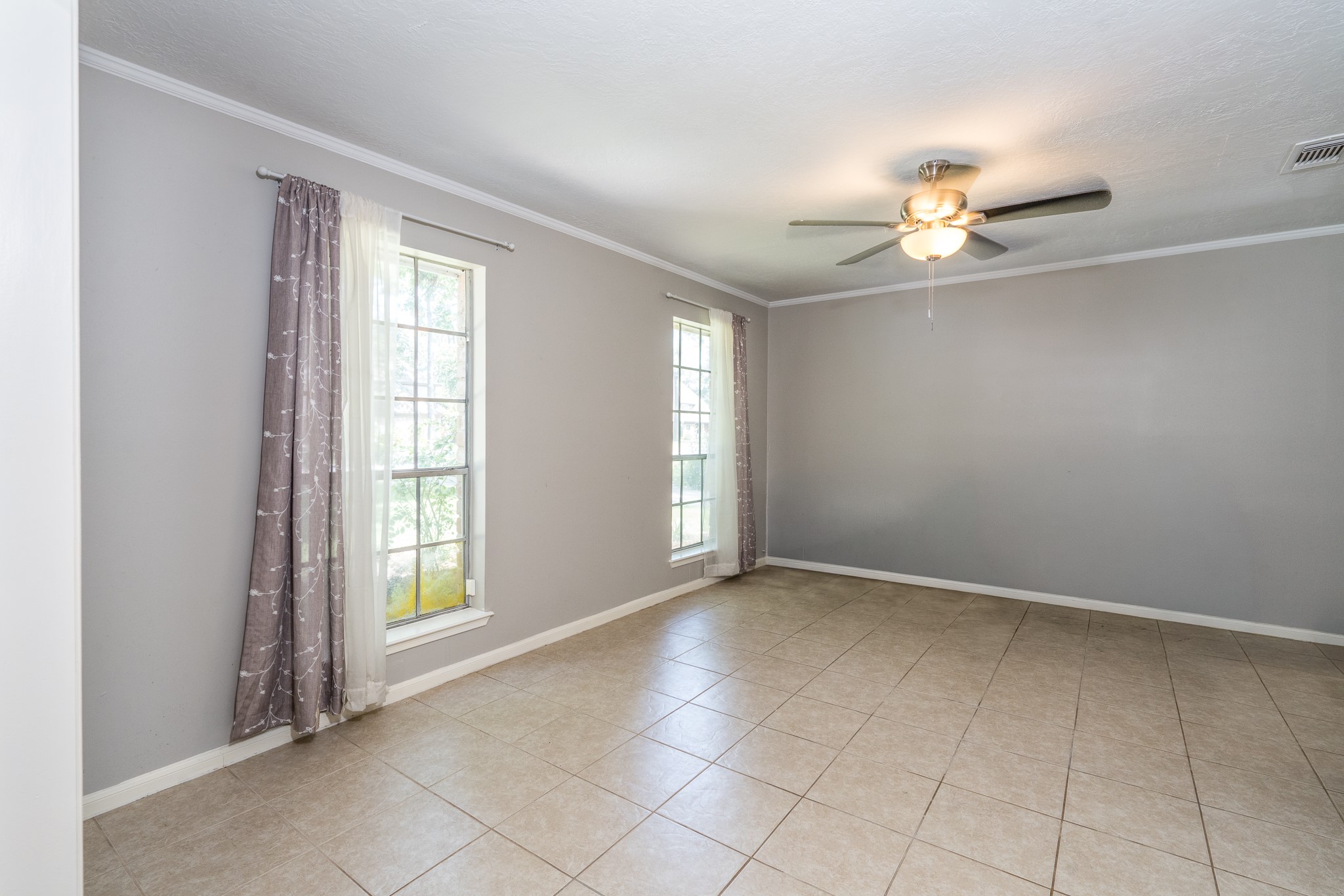 6527 Castle Pine Lane Spring, TX 77379 - Photo 11 of 47 Off the welcoming entry is a spacious formal living area or oversized dining space, offering flexibility to suit your lifestyle and entertaining needs.