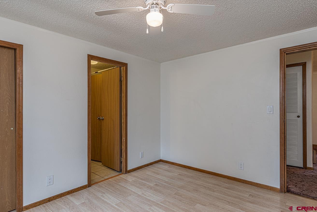 32 Hidden Lane Durango, CO 81303 - Photo 15 of 26 a view of an empty room with wooden floor and a window