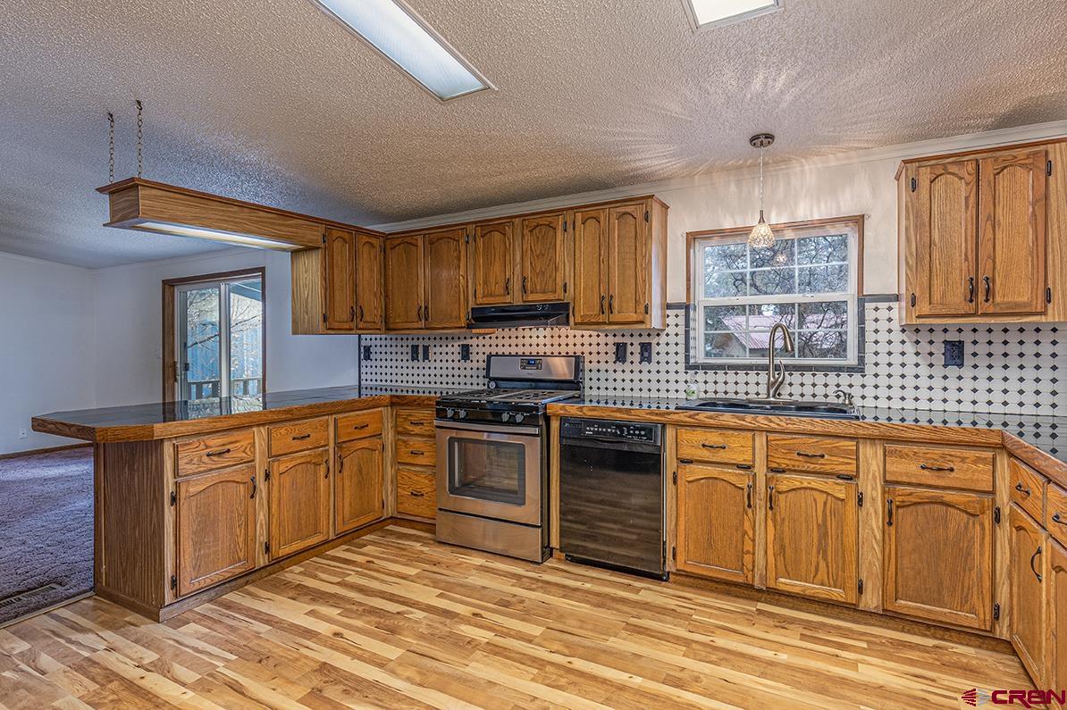 32 Hidden Lane Durango, CO 81303 - Photo 2 of 26 a kitchen with stainless steel appliances granite countertop a stove sink and cabinets