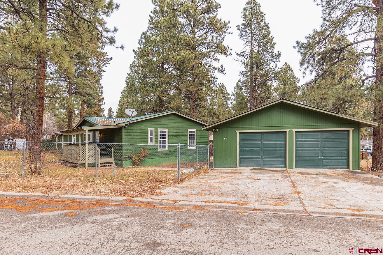 32 Hidden Lane Durango, CO 81303 - Photo 26 of 26 a view of house with a yard and large trees