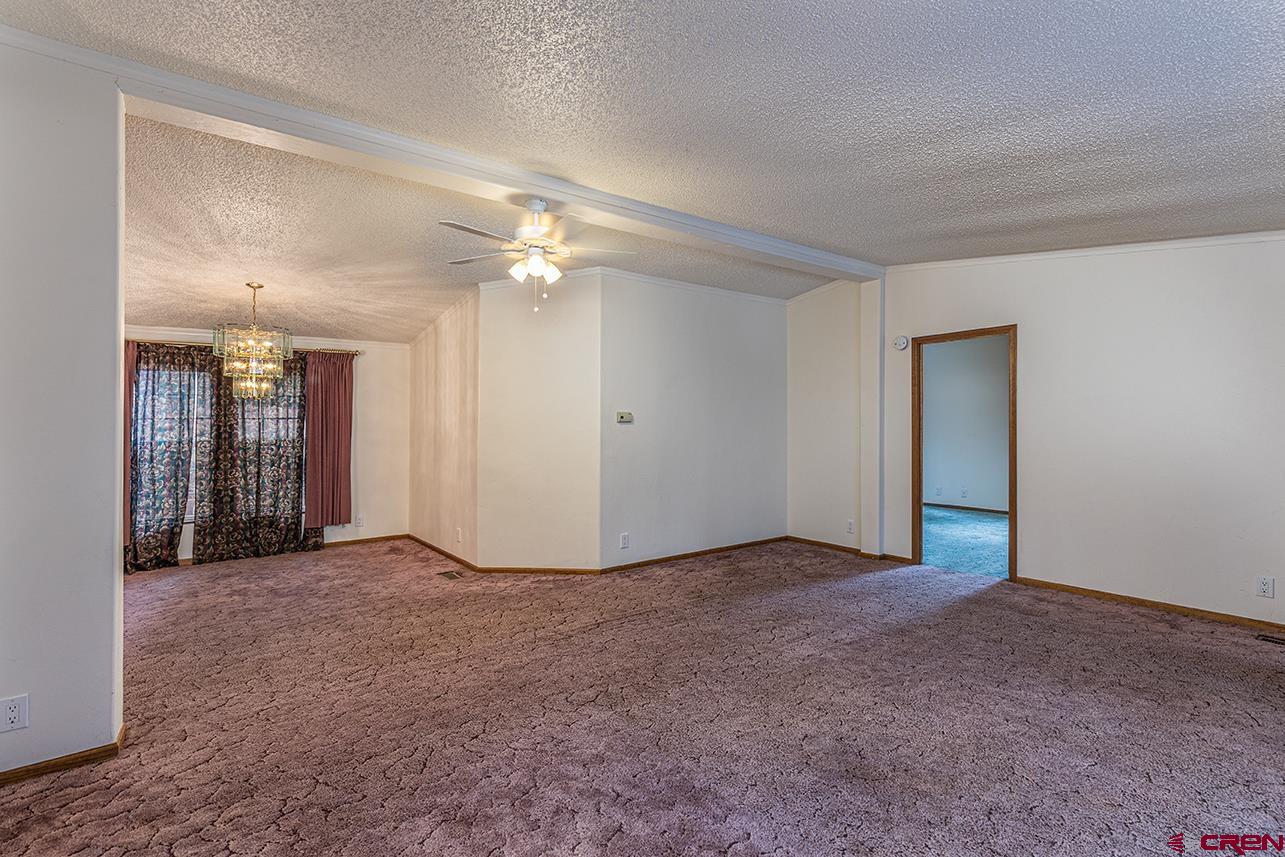32 Hidden Lane Durango, CO 81303 - Photo 5 of 26 a view of an empty room with a fireplace