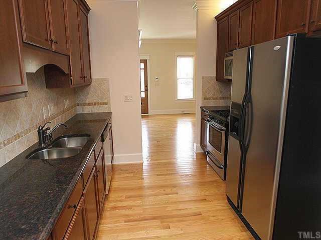 508 Chamberlain Street, Unit A & B Raleigh, NC 27607 - Photo 4 of 10 a kitchen with granite countertop a refrigerator stove and sink