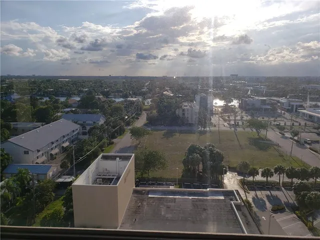 a view of a patio with couches potted plants and a swimming pool