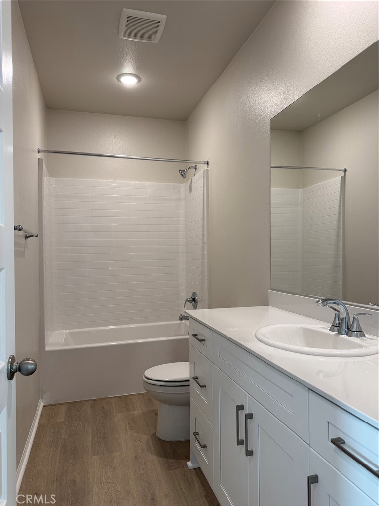 1120 Tropic Court, Unit 306 Redlands, CA 92374 - Photo 13 of 18 a bathroom with a sink a toilet and shower