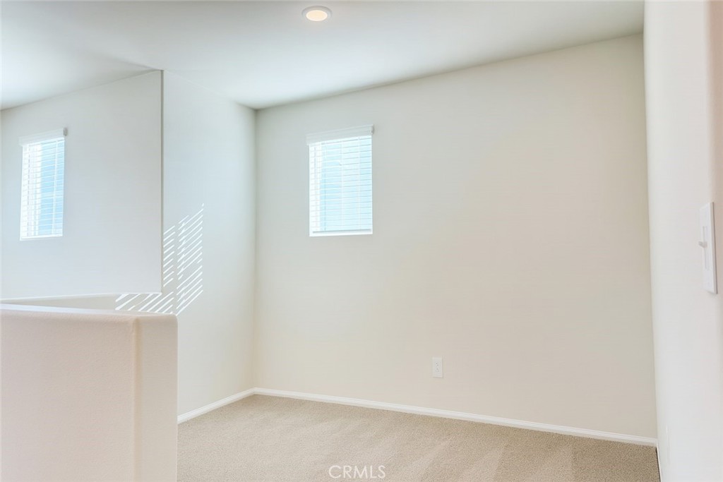 1120 Tropic Court, Unit 306 Redlands, CA 92374 - Photo 6 of 18 an empty room with windows