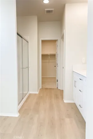 a spacious bathroom with a sink a mirror and a shower