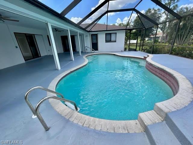 9115 Morris Road Fort Myers, FL 33967 - Photo 16 of 46 a view of a house with a swimming pool and porch