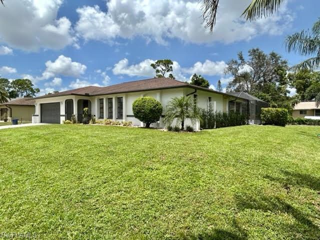 9115 Morris Road Fort Myers, FL 33967 - Photo 2 of 46 a front view of house with yard and green space