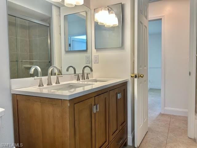 9115 Morris Road Fort Myers, FL 33967 - Photo 26 of 46 a bathroom with a double vanity sink and a mirror