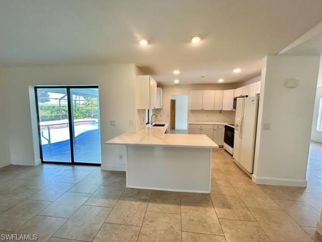 9115 Morris Road Fort Myers, FL 33967 - Photo 34 of 46 a view of kitchen with stainless steel appliances granite countertop a stove top oven a sink and a refrigerator