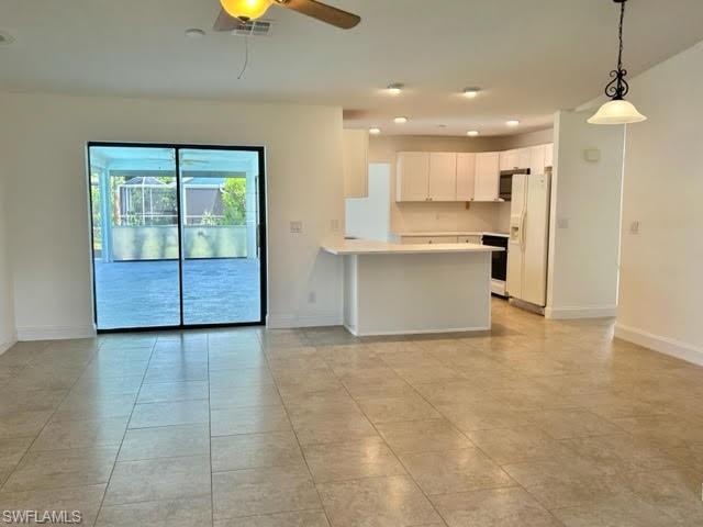 9115 Morris Road Fort Myers, FL 33967 - Photo 37 of 46 a view of a kitchen with a sink and a living room