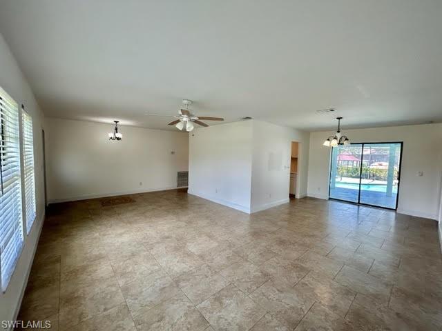 9115 Morris Road Fort Myers, FL 33967 - Photo 39 of 46 an empty room with chandelier fan and windows