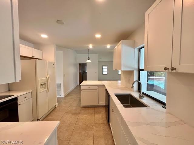 9115 Morris Road Fort Myers, FL 33967 - Photo 41 of 46 a large kitchen with stainless steel appliances kitchen island granite countertop a sink and cabinets