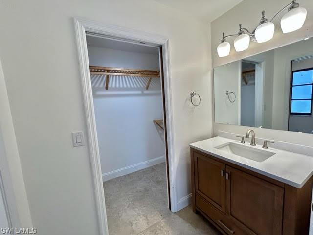 9115 Morris Road Fort Myers, FL 33967 - Photo 44 of 46 a spacious bathroom with a double vanity sink and a mirror