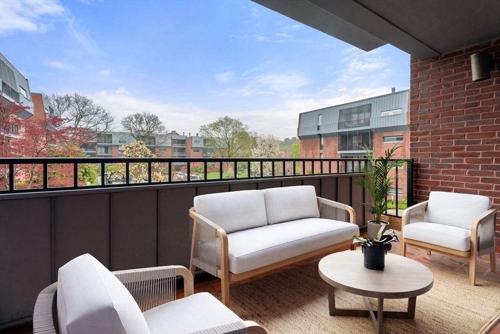 75 Grove Street, Unit 227 Wellesley, MA 02482 - Photo 11 of 29 a balcony with furniture and a potted plant