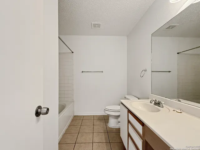 an empty room with a ceiling fan and a window