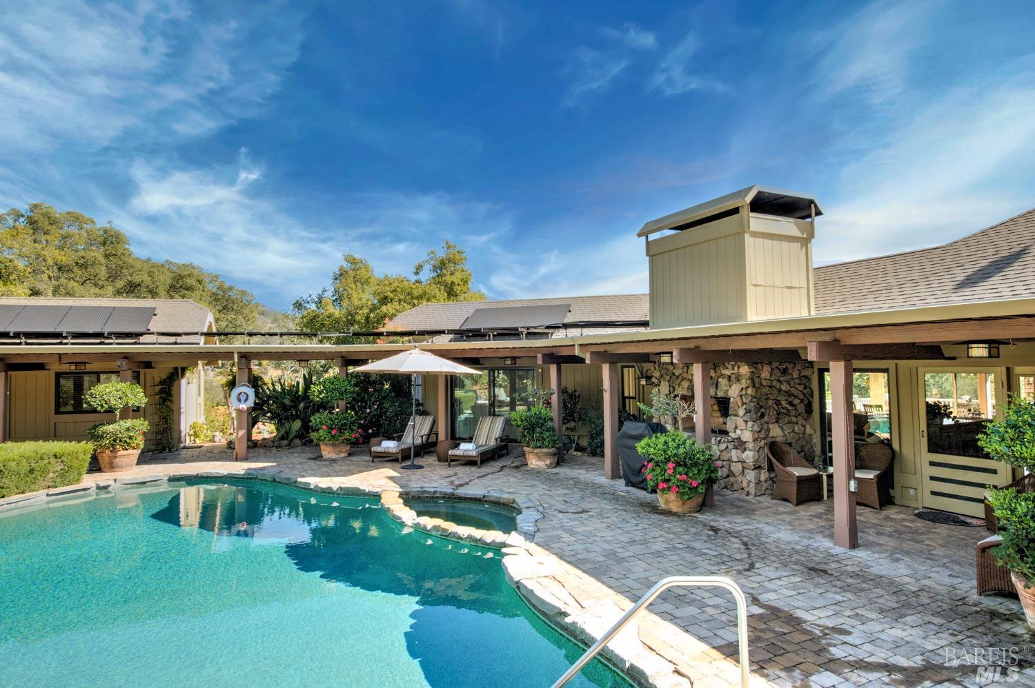 a view of a house with backyard porch and sitting area