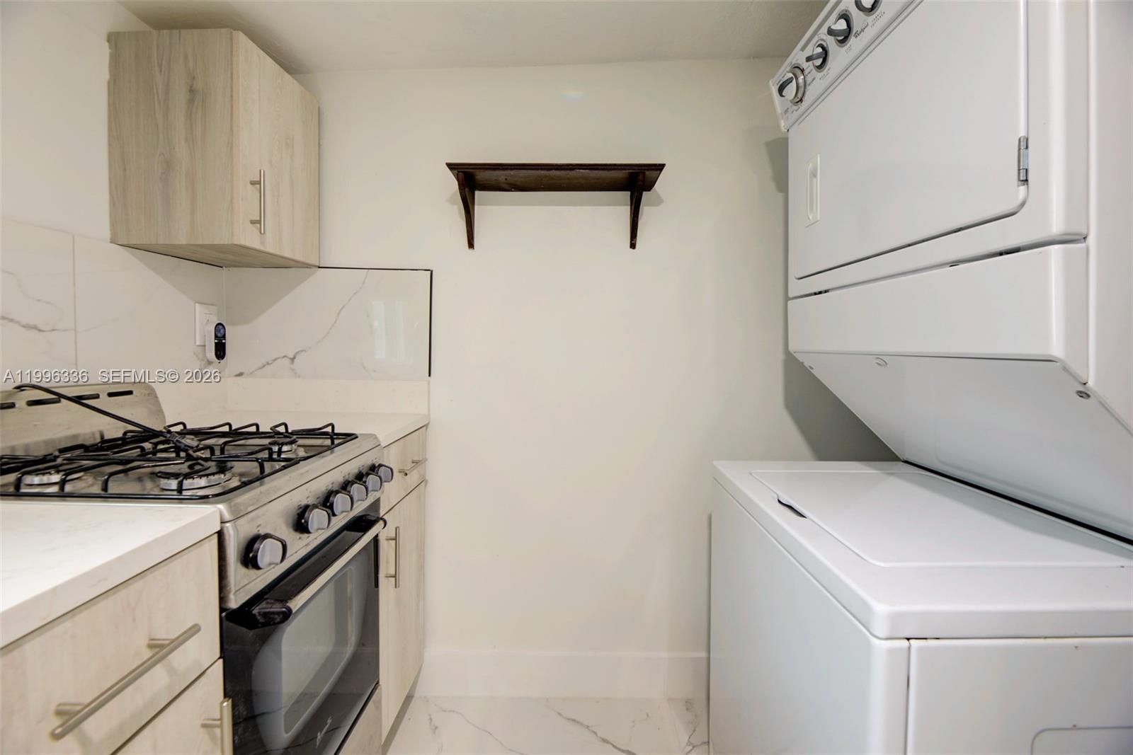 20201 Southwest 117th Court Miami, FL 33177 - Photo 12 of 18 a kitchen with a stove and a refrigerator