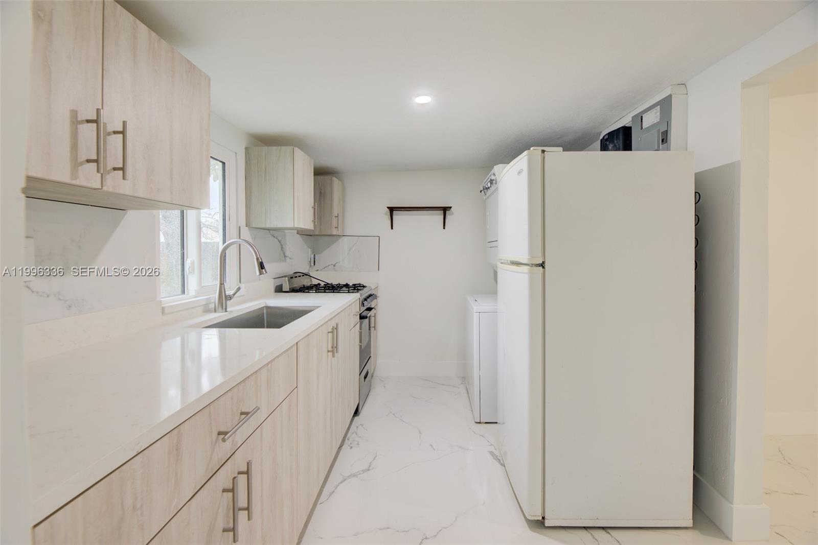 20201 Southwest 117th Court Miami, FL 33177 - Photo 14 of 18 a kitchen with refrigerator and cabinets