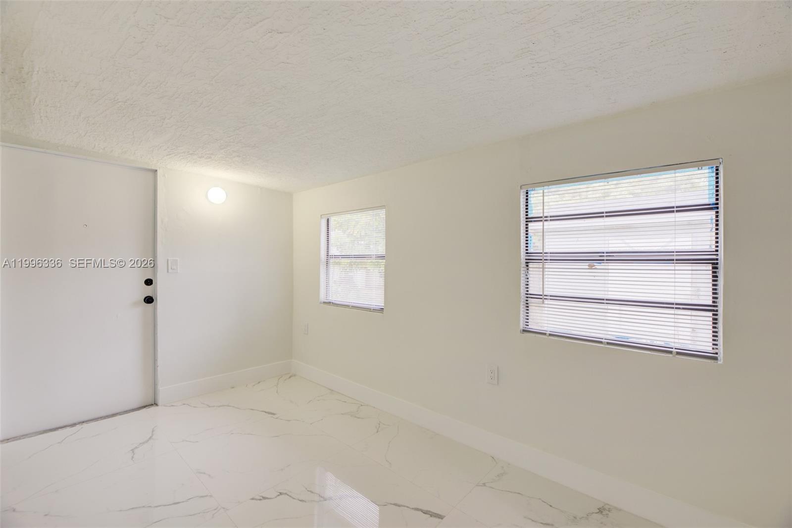 20201 Southwest 117th Court Miami, FL 33177 - Photo 15 of 18 a view of empty room with windows