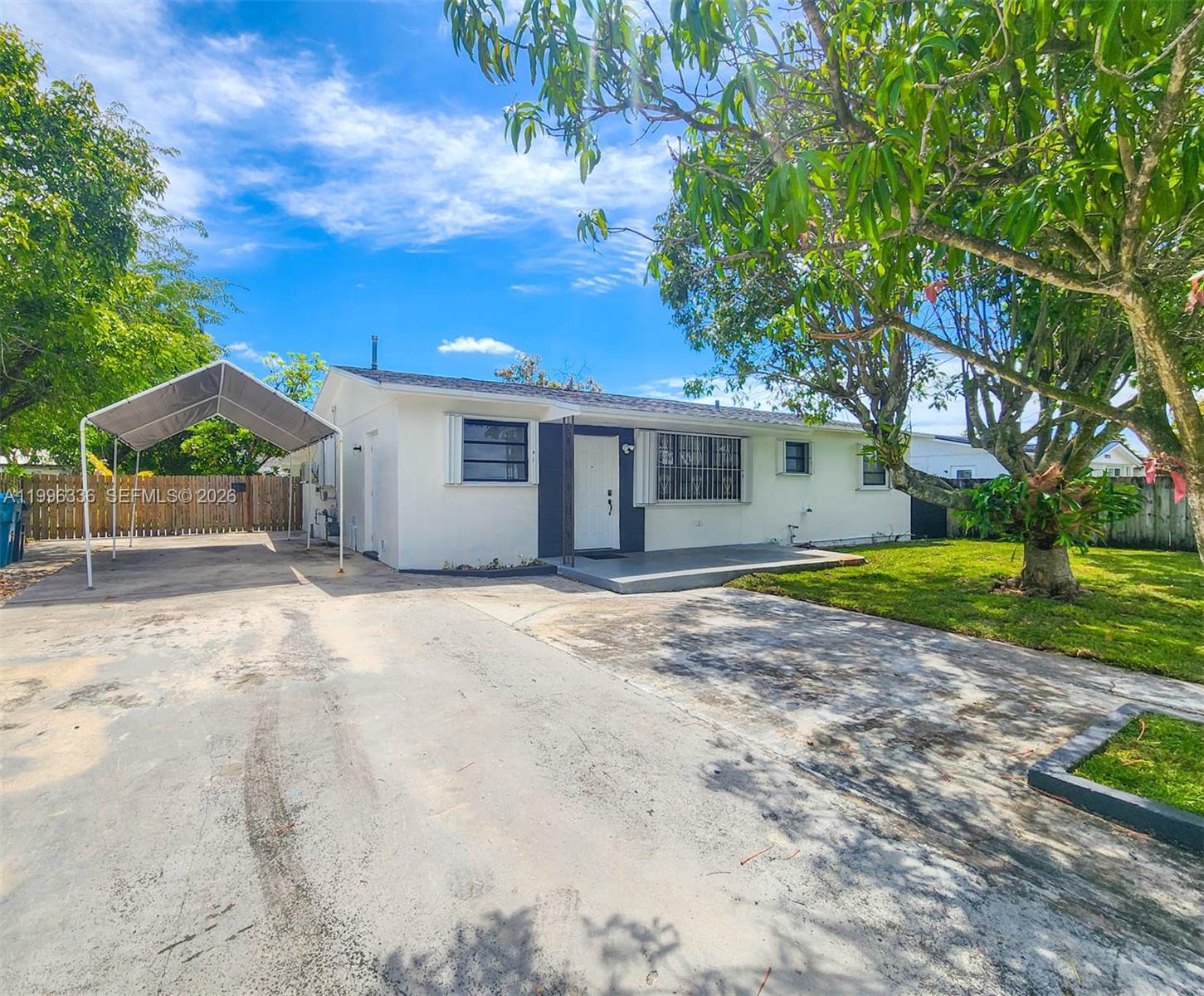 20201 Southwest 117th Court Miami, FL 33177 - Photo 18 of 18 a view of a house with backyard and tree