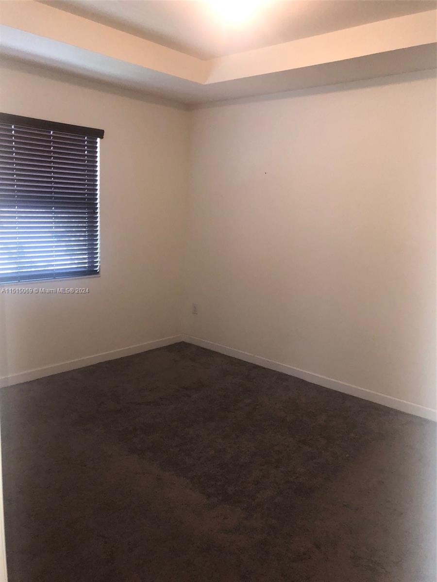 15053 Southwest 115th Terrace Miami, FL 33196 - Photo 26 of 29 a view of an empty room with wooden floor and a window