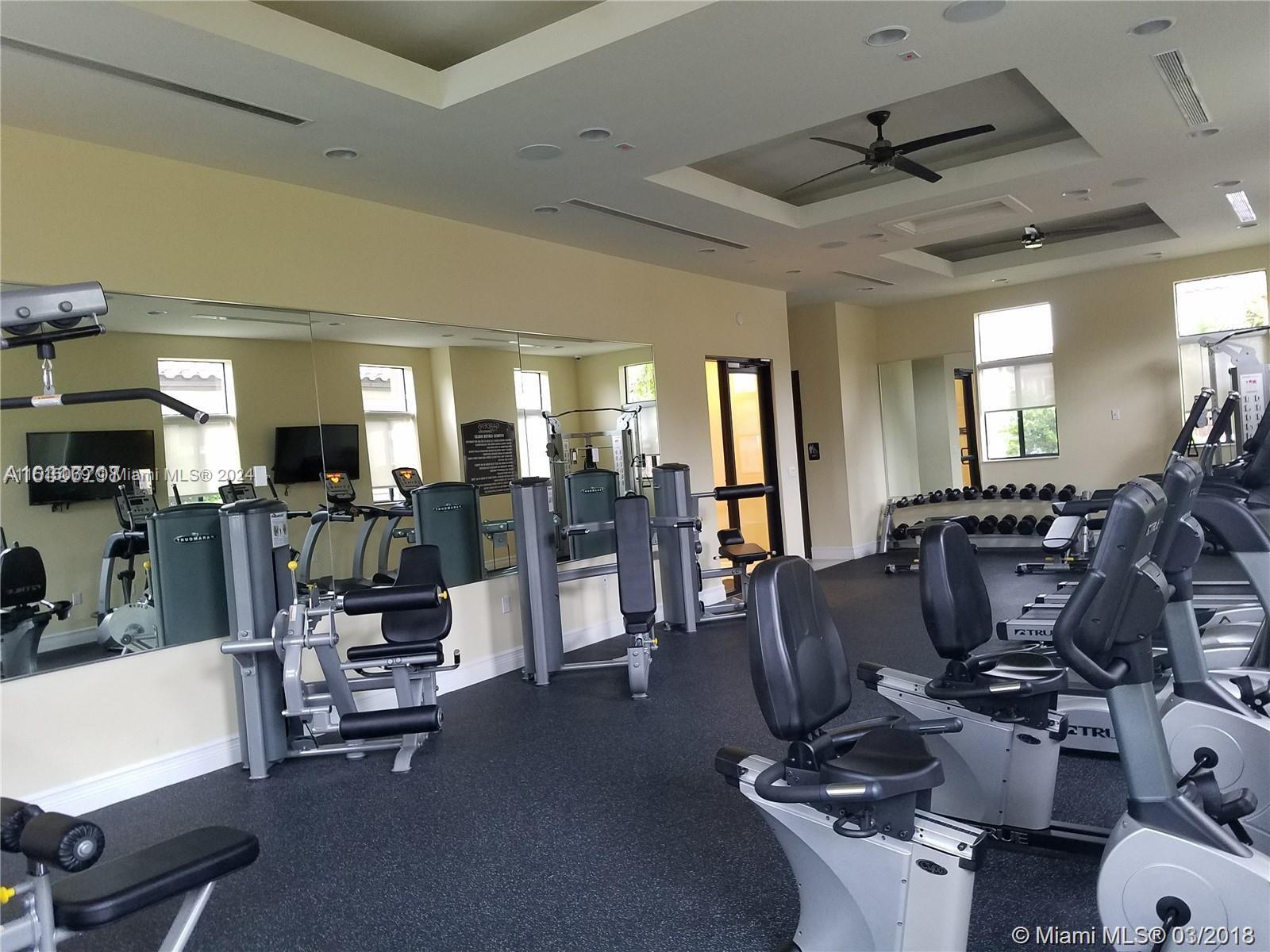15053 Southwest 115th Terrace Miami, FL 33196 - Photo 6 of 29 a room with gym equipment and large mirror