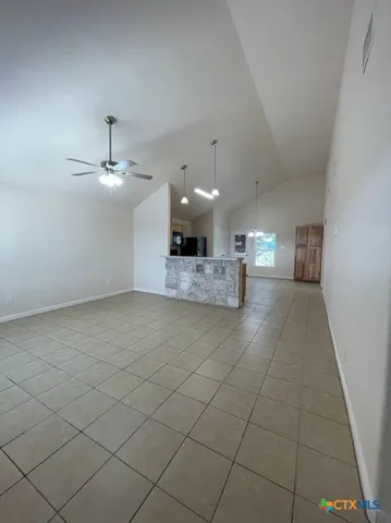 an open kitchen with a sink and chandelier