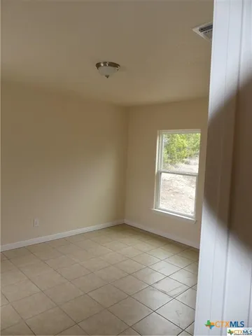 an empty room with a empty space and a window