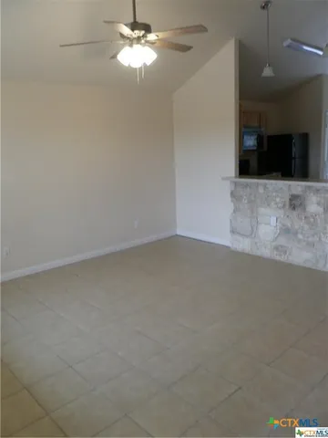 an empty room with a kitchen