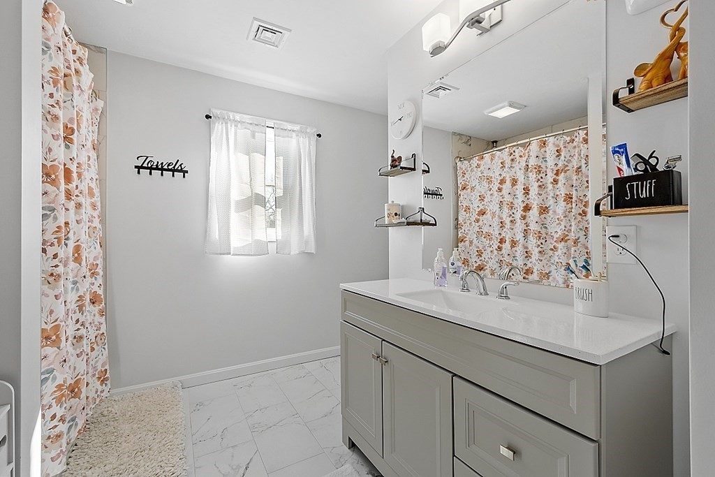 36 Pine Street Dudley, MA 01571 - Photo 13 of 26 a bathroom with a sink and a mirror