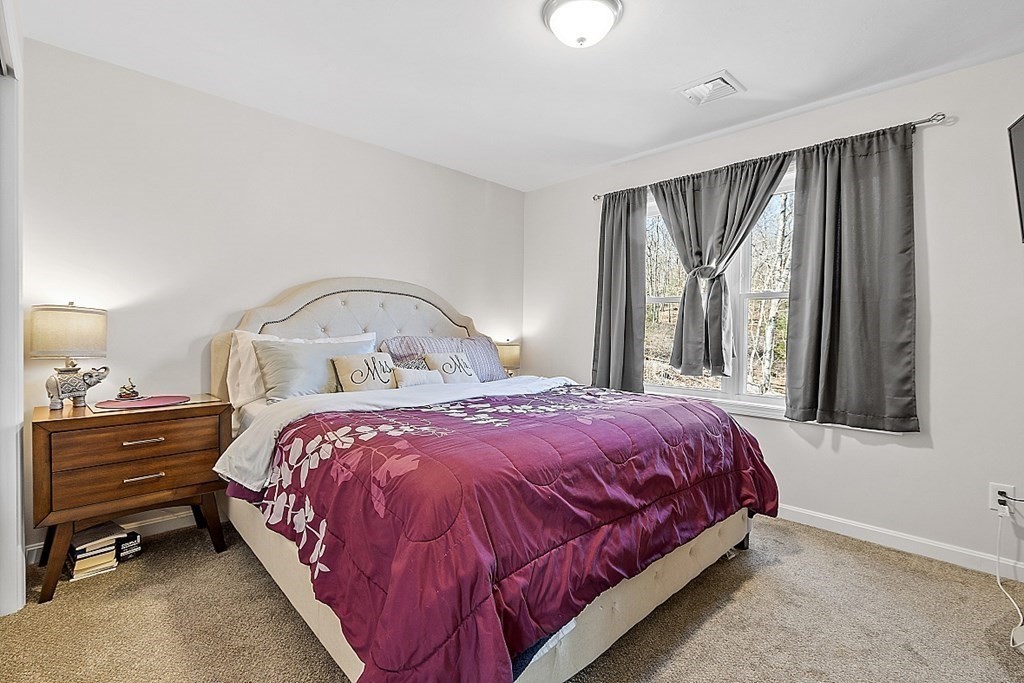36 Pine Street Dudley, MA 01571 - Photo 14 of 26 a bedroom with a bed and a window