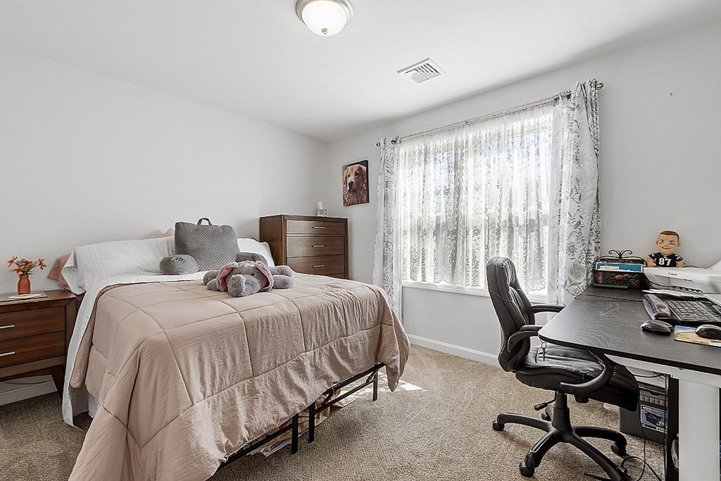 36 Pine Street Dudley, MA 01571 - Photo 16 of 26 a bedroom with a bed and a desk