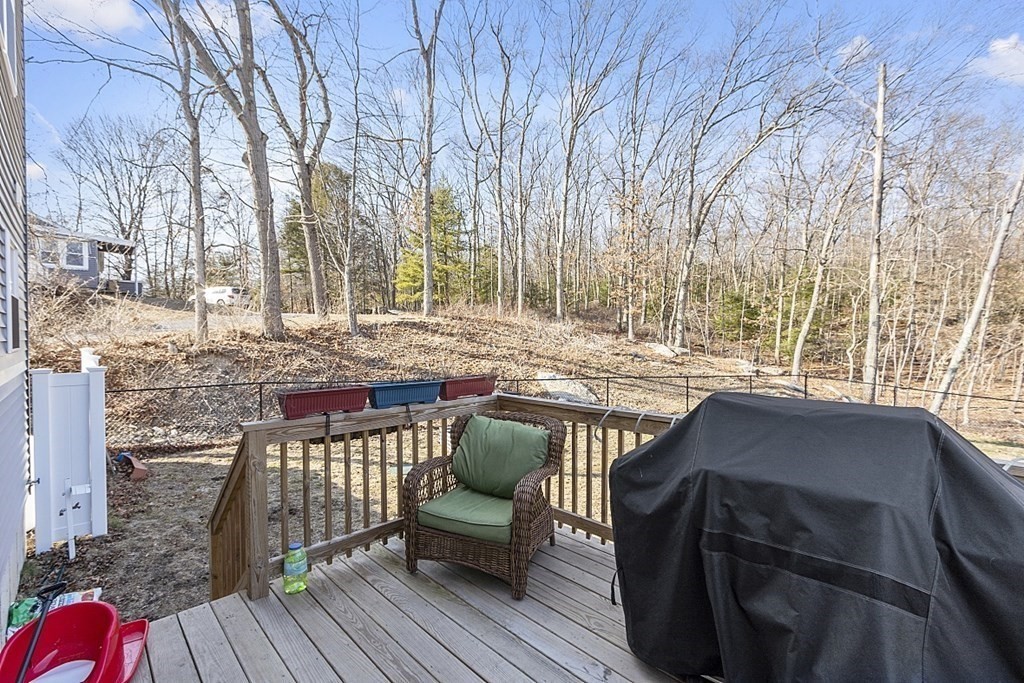 36 Pine Street Dudley, MA 01571 - Photo 18 of 26 a view of a roof deck with table and chairs a barbeque with wooden floor and fence