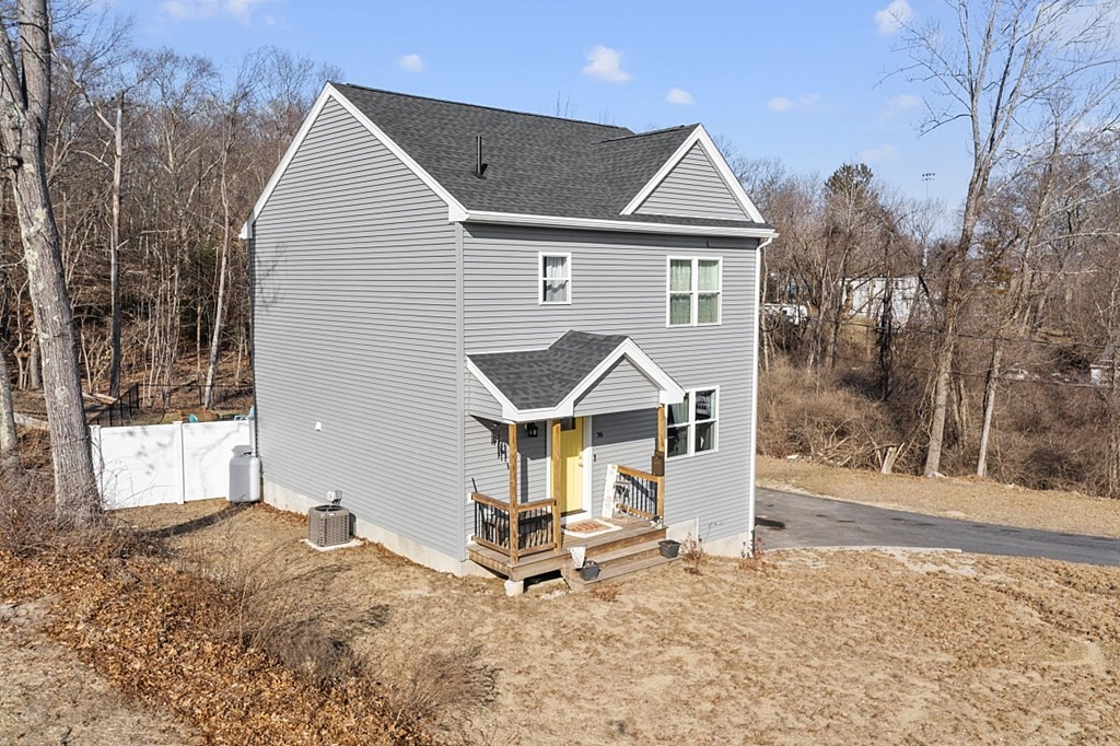 36 Pine Street Dudley, MA 01571 - Photo 23 of 26 a front view of a house with a yard and garage