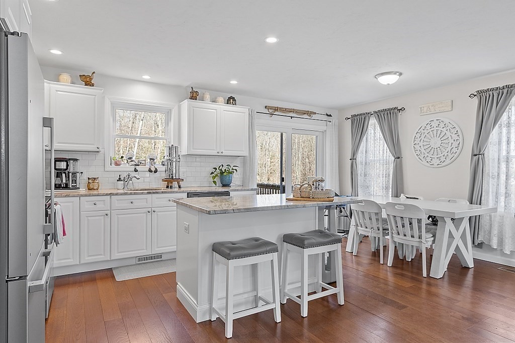 36 Pine Street Dudley, MA 01571 - Photo 4 of 26 a kitchen with stainless steel appliances granite countertop a table chairs sink and cabinets