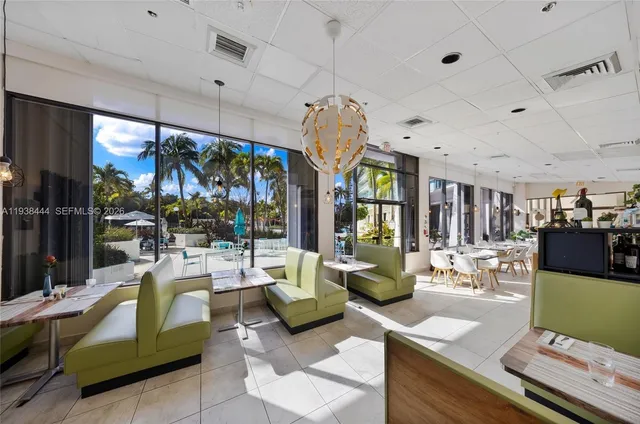 a living room with lots of furniture and a large window
