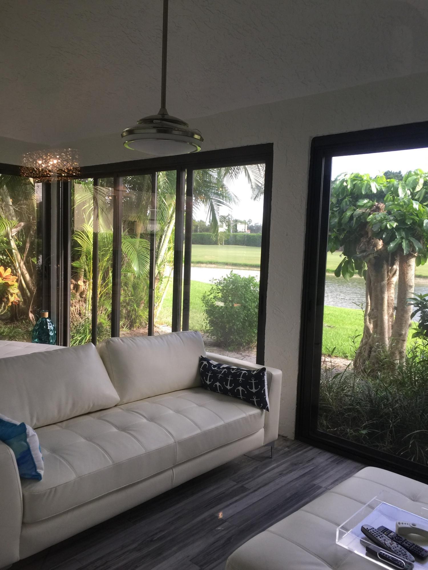 7770 La Mirada Drive Boca Raton, FL 33433 - Photo 19 of 55 a living room with furniture and a floor to ceiling window