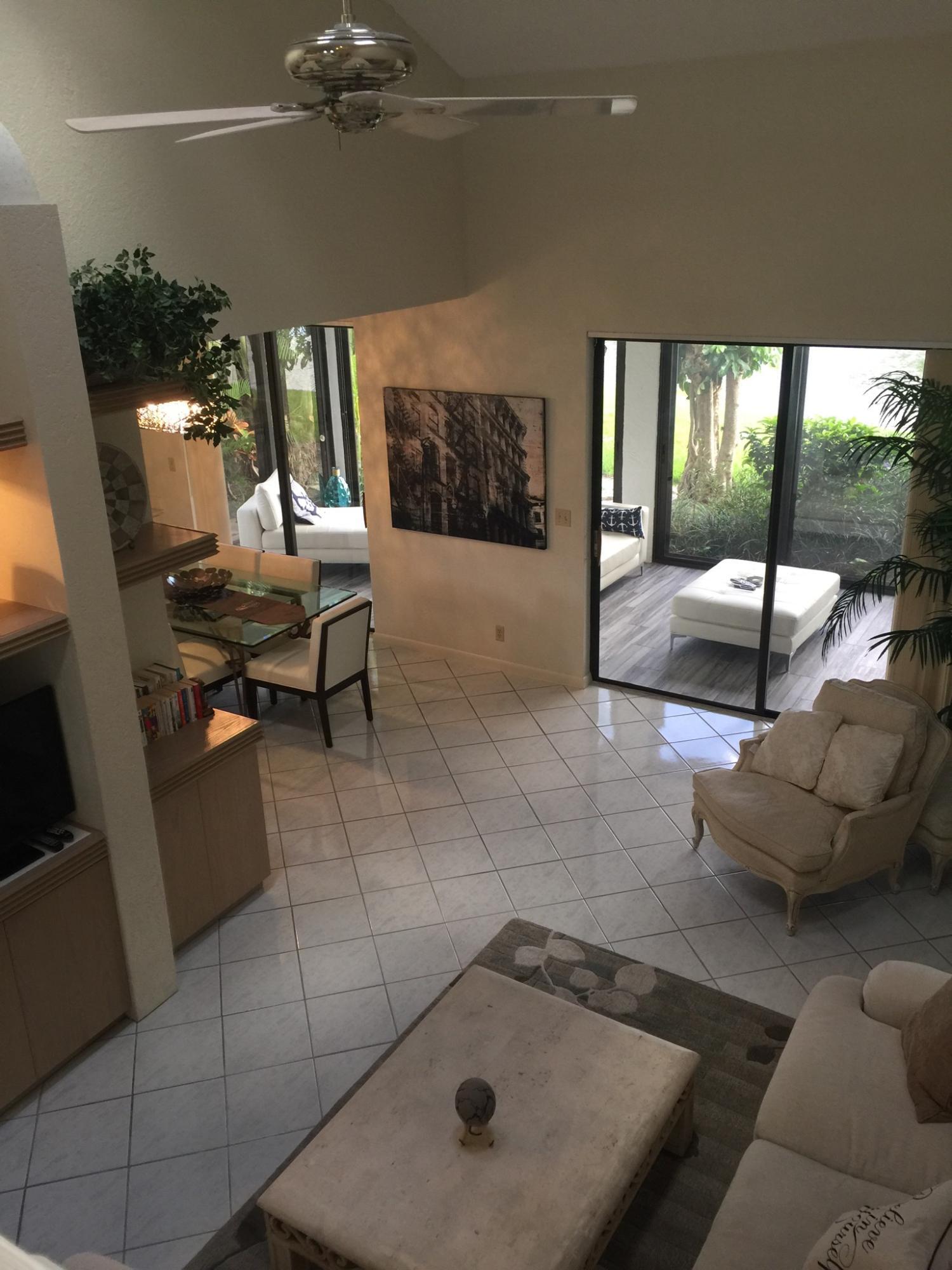 7770 La Mirada Drive Boca Raton, FL 33433 - Photo 7 of 55 a living room with furniture and a floor to ceiling window