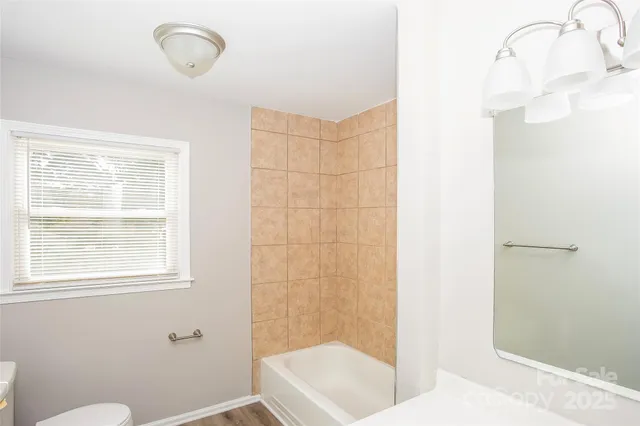a bathroom with a shower and a sink